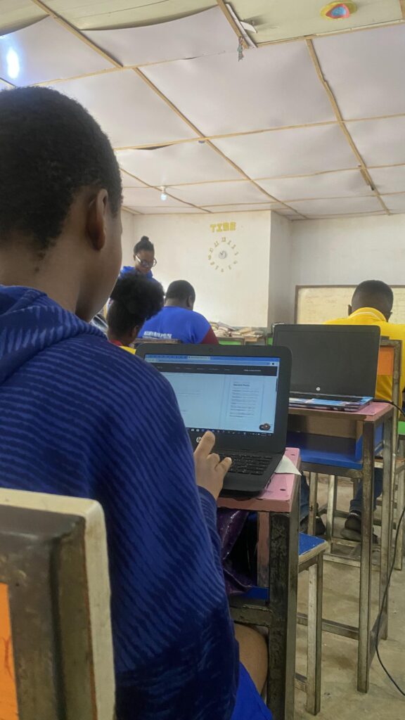 A female student with a laptop in her front having tech examination in a class room - EpeeTech Solution (Cardon Standard Schools)